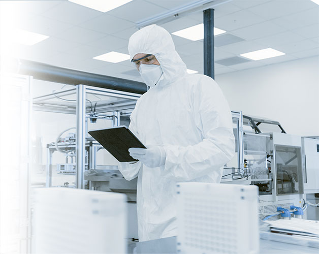 A photo of a lab technician holding a tablet